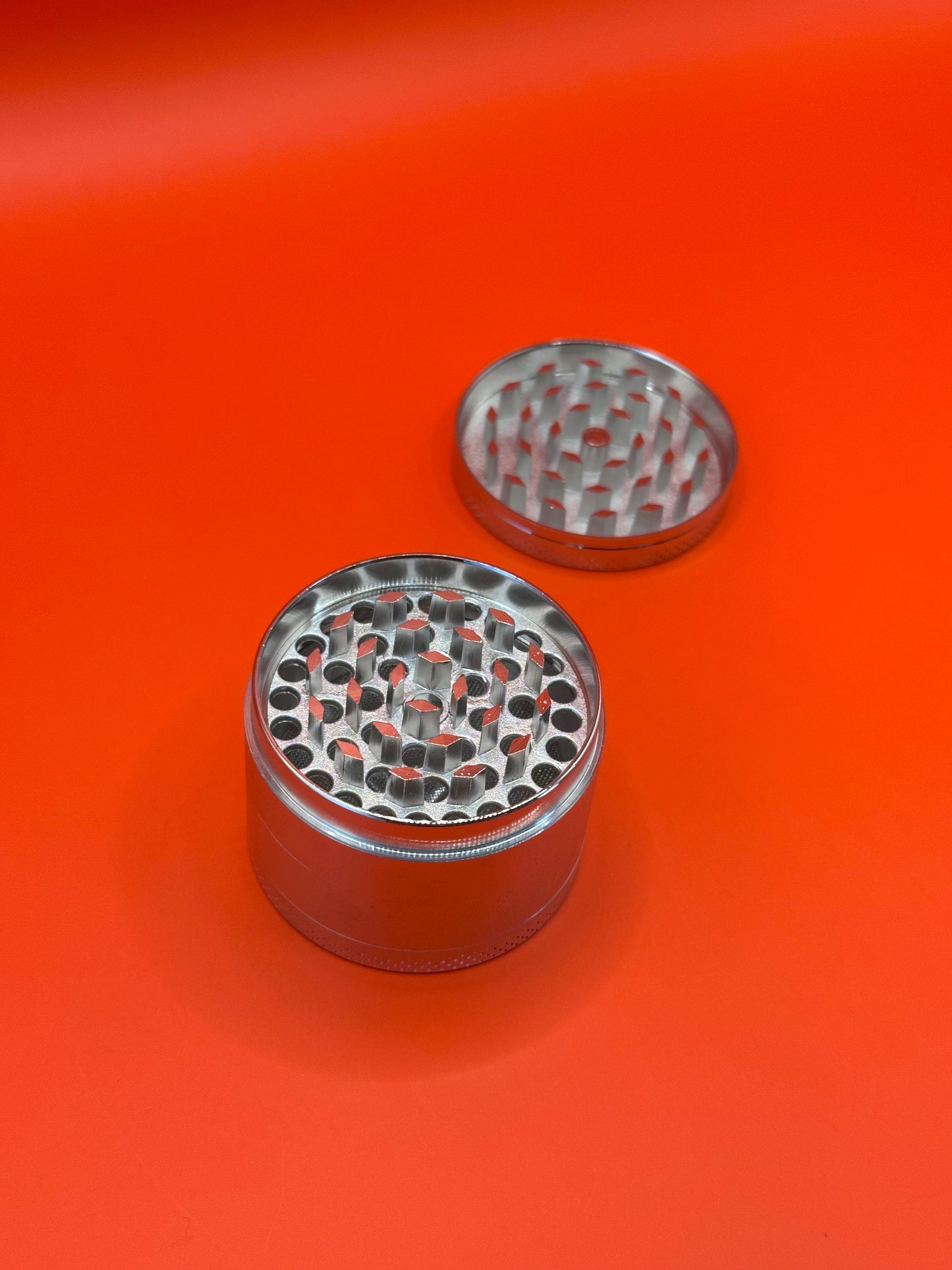 55mm shiny Metal Grinder with kief collector and scoop.